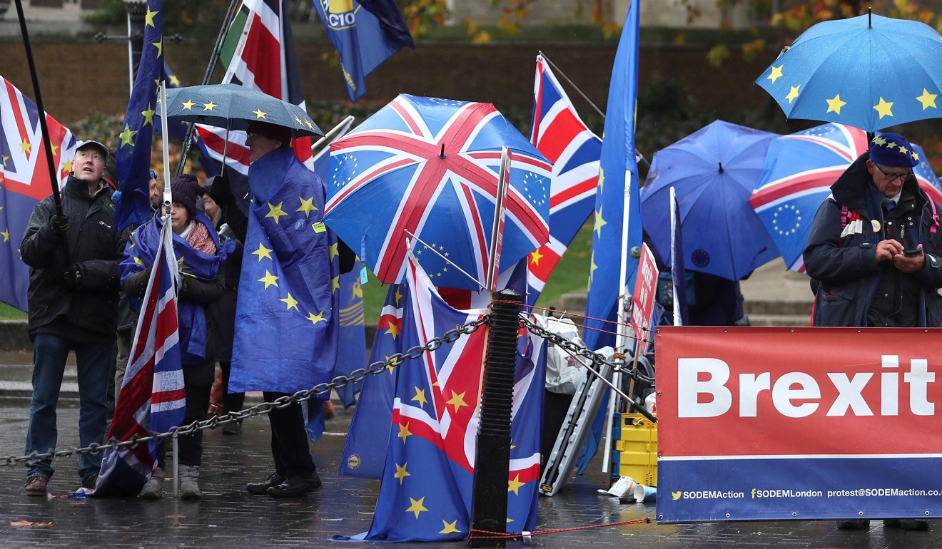 Pro-European Union demonstrators wave EU and Union flags as they protest outside the Houses of Parliament in London on Tuesday. Photo: AFP