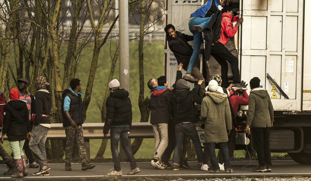 Refugees climbing into a truck in Calais. Photo: AFP