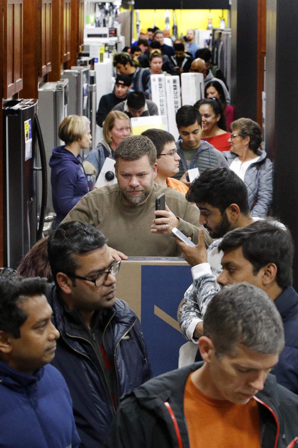 People line up to pay for their purchases during an early Black Friday sale in the United States, which is still the world’s largest consumer market. Photo: AP