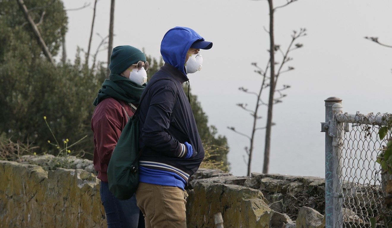 A couple standing on Alcatraz Island in San Francisco Bay look out to the bay obscured by smoke and haze from wildfires, on November 15. For residents of San Francisco, the pollution brings home the reality that, with unchecked global warming, California will continue to be subject to drought, and can expect the fire season’s trend to worsen. Photo: AP