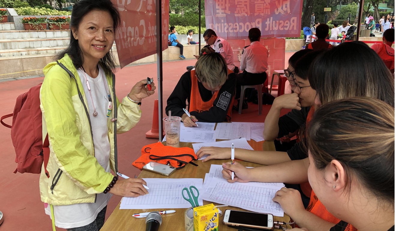 Orienteering coach Rainsky Cheung Wei-ki collects an electronic time chip at the Tuen Mun Park “Orienteering@Park” event in Hong Kong. Photo: Nora Tong