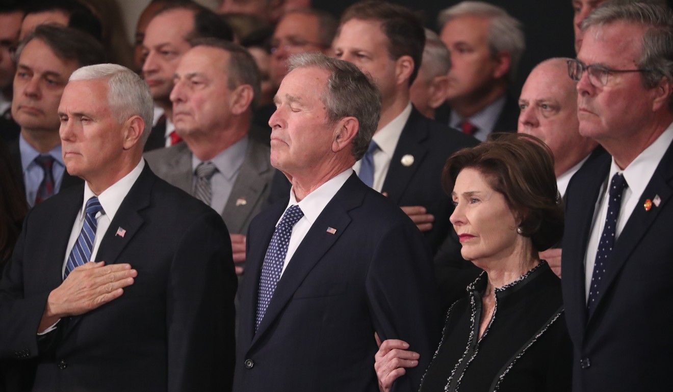 US Vice-President Mike Pence, former president George W. Bush and former first lady Laura Bush watch as the casket of former president George H.W. Bush arrives to lie in state in the US Capitol Rotunda in Washington. Photo: EPA