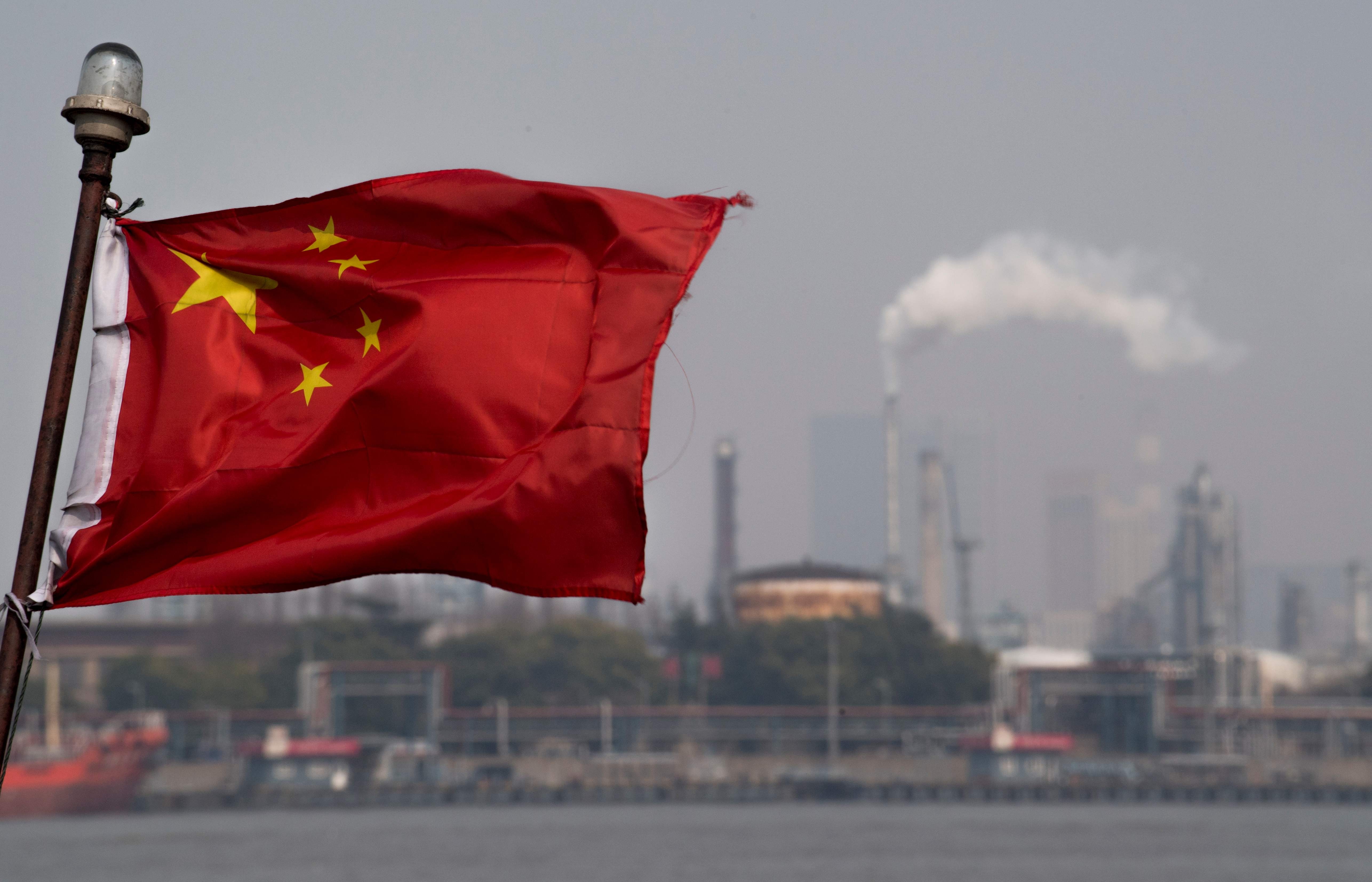 A Chinese flag flutters in front of a Sinopec Shanghai Gaoqiao refinery. China’s yuan-denominated oil futures, launched in March, have overtaken in volume the dollar-denominated oil futures traded in Singapore and Dubai. Photo: AFP