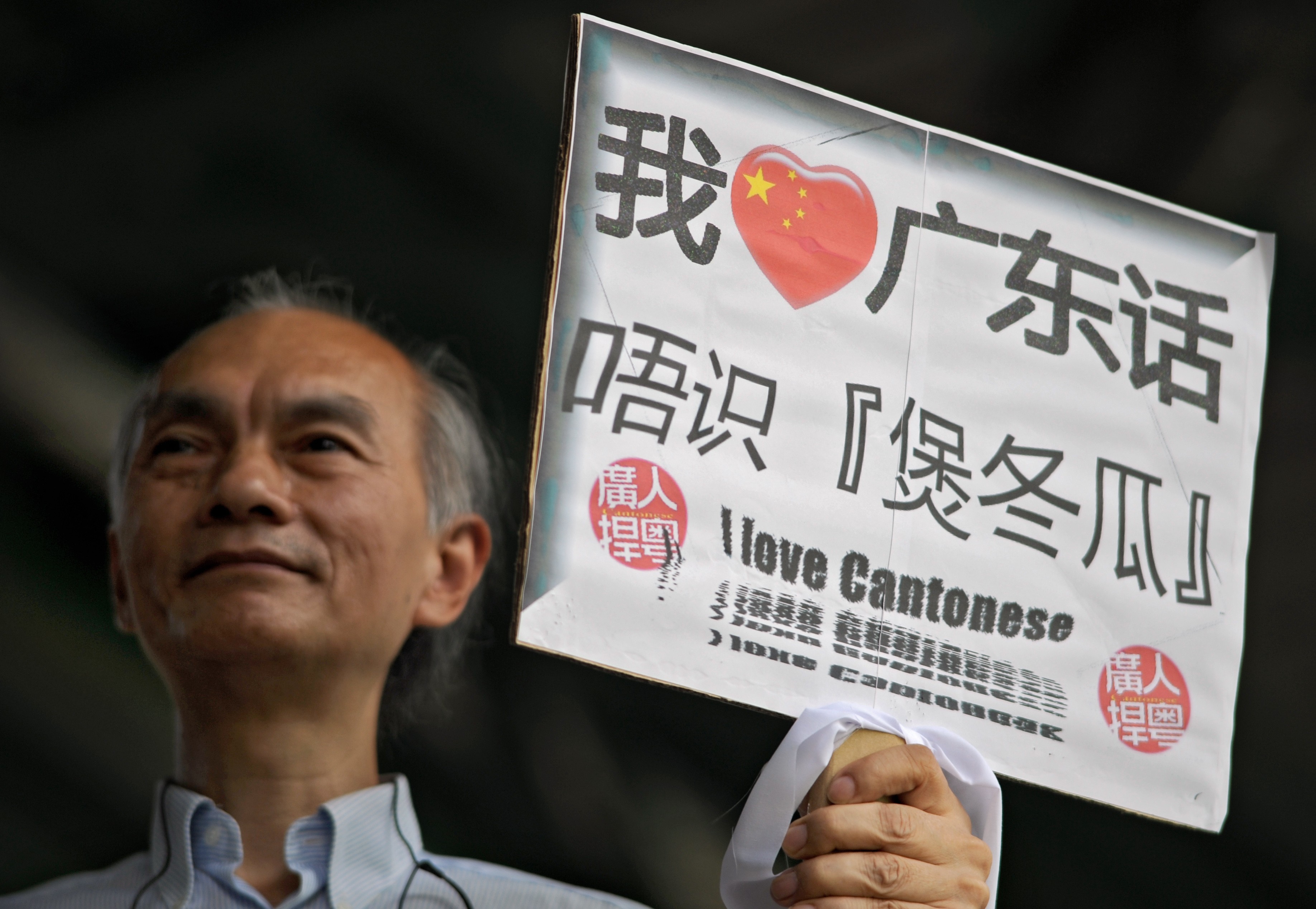 A man declares his love for Cantonese, and disdain for Mandarin, on a placard. Photo: AFP
