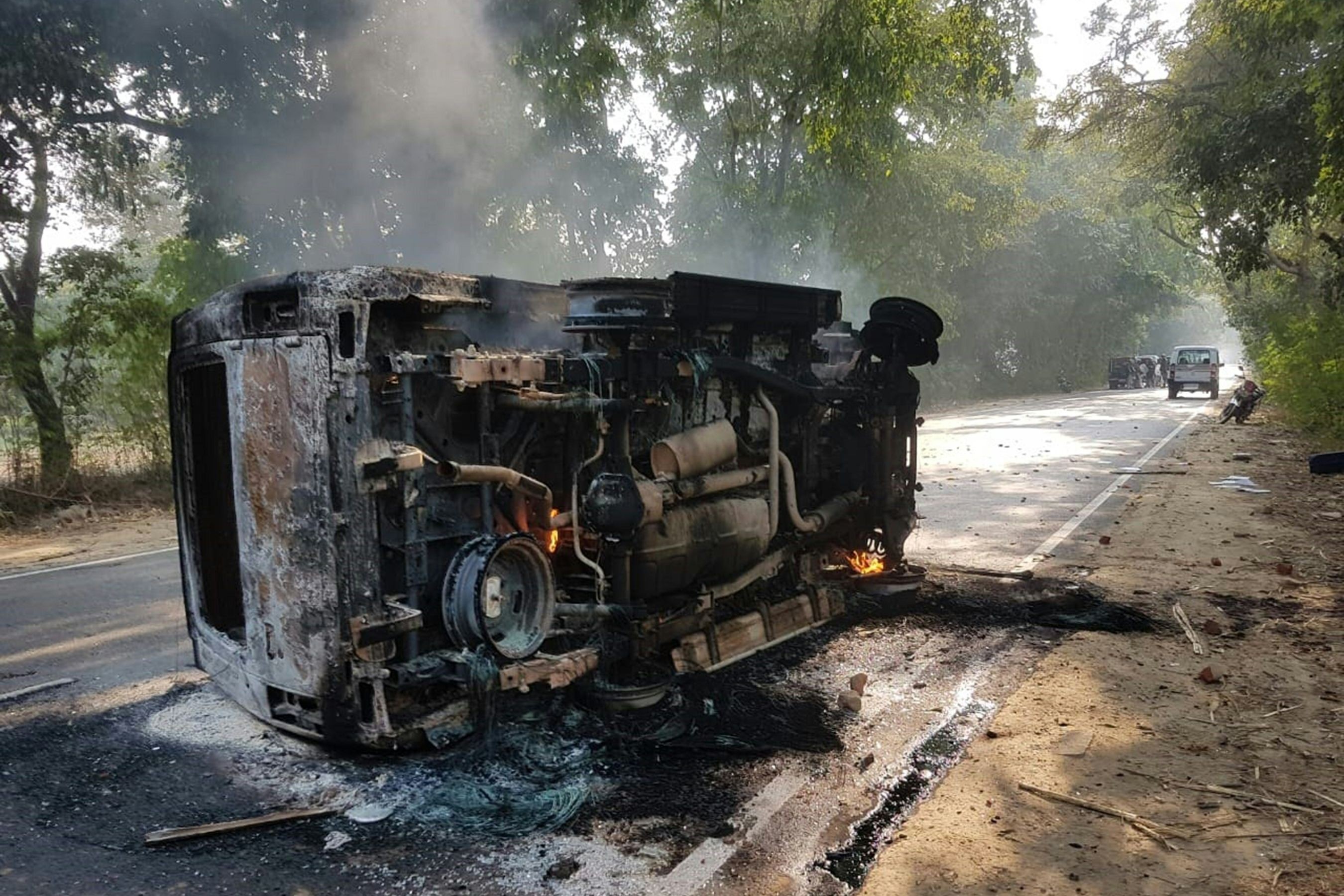 An upturned, smouldering vehicle in the aftermath of mob violence at Chingravati village. Photo: AFP