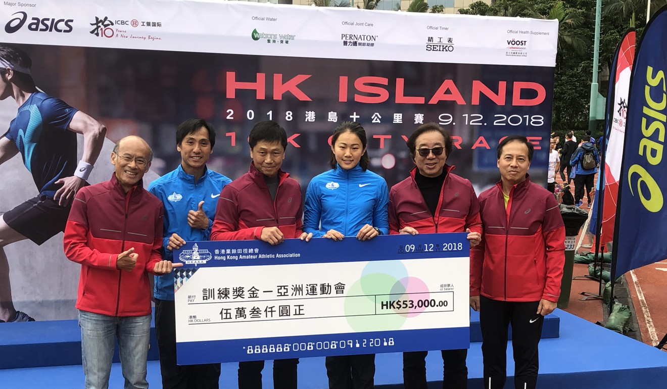 Hurdler Vera Lui (third from right) receives a HK$53,000 training grant from the Amateur Athletic Association at Wan Chai Sports Ground. Photo: Chan Kin-wa