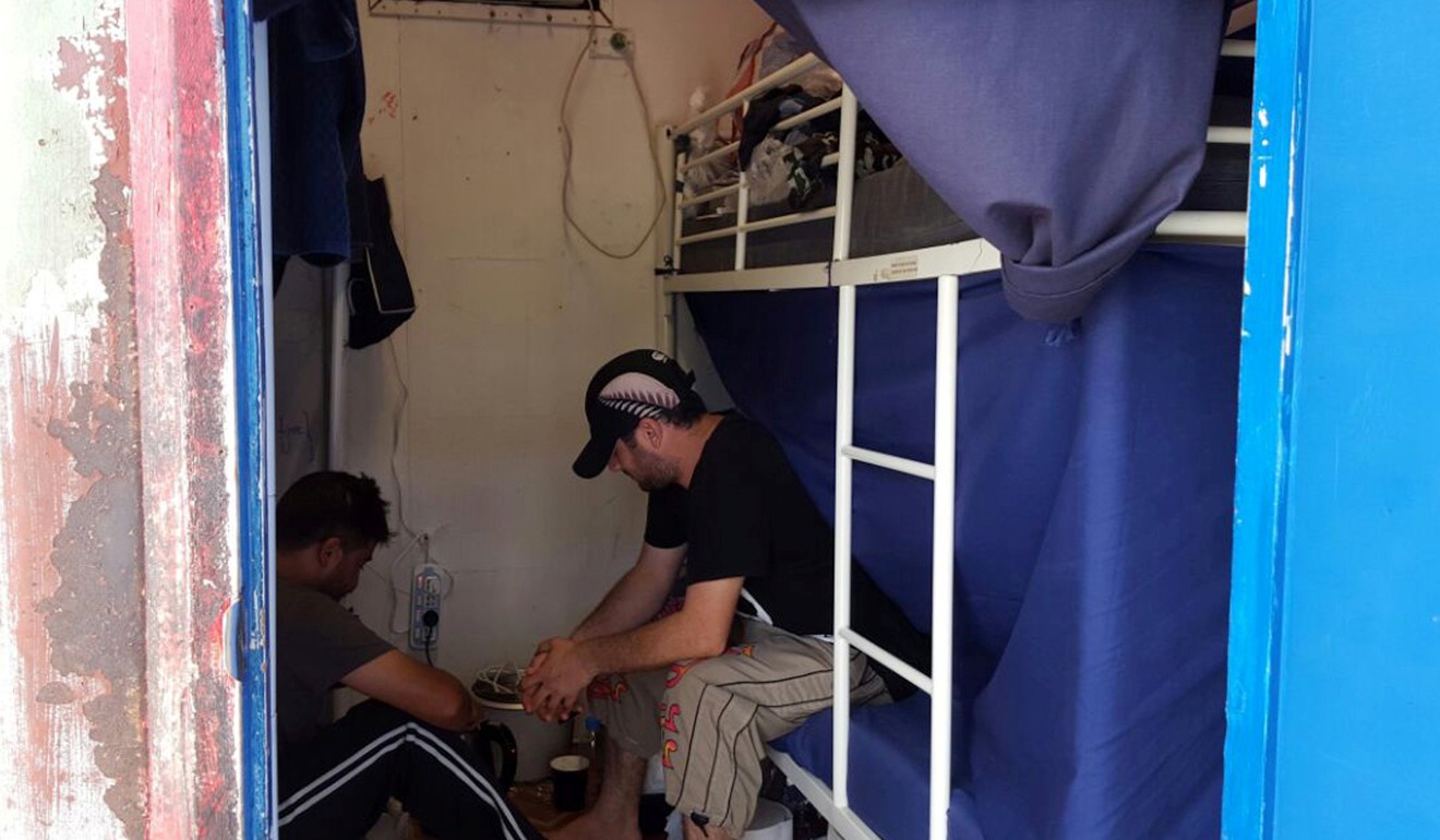 Detainees sit inside accommodation at the Manus Island detention centre. Photo: Reuters