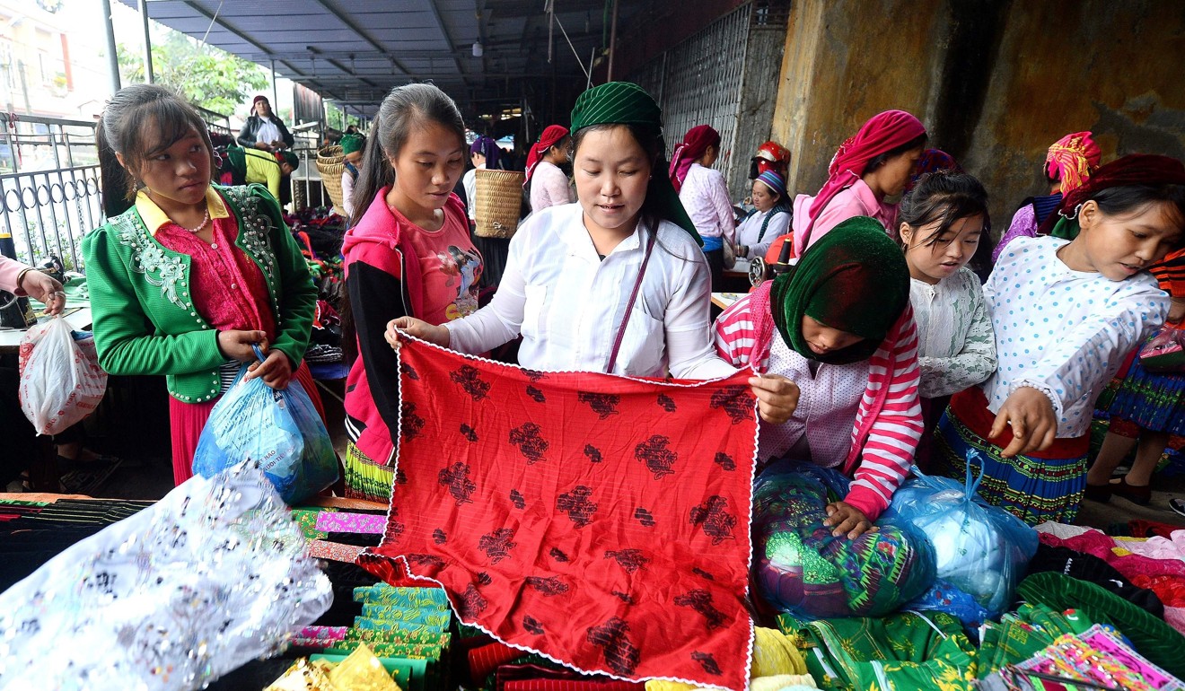 Women shop at a market of the type that traffickers frequent. Photo: AFP