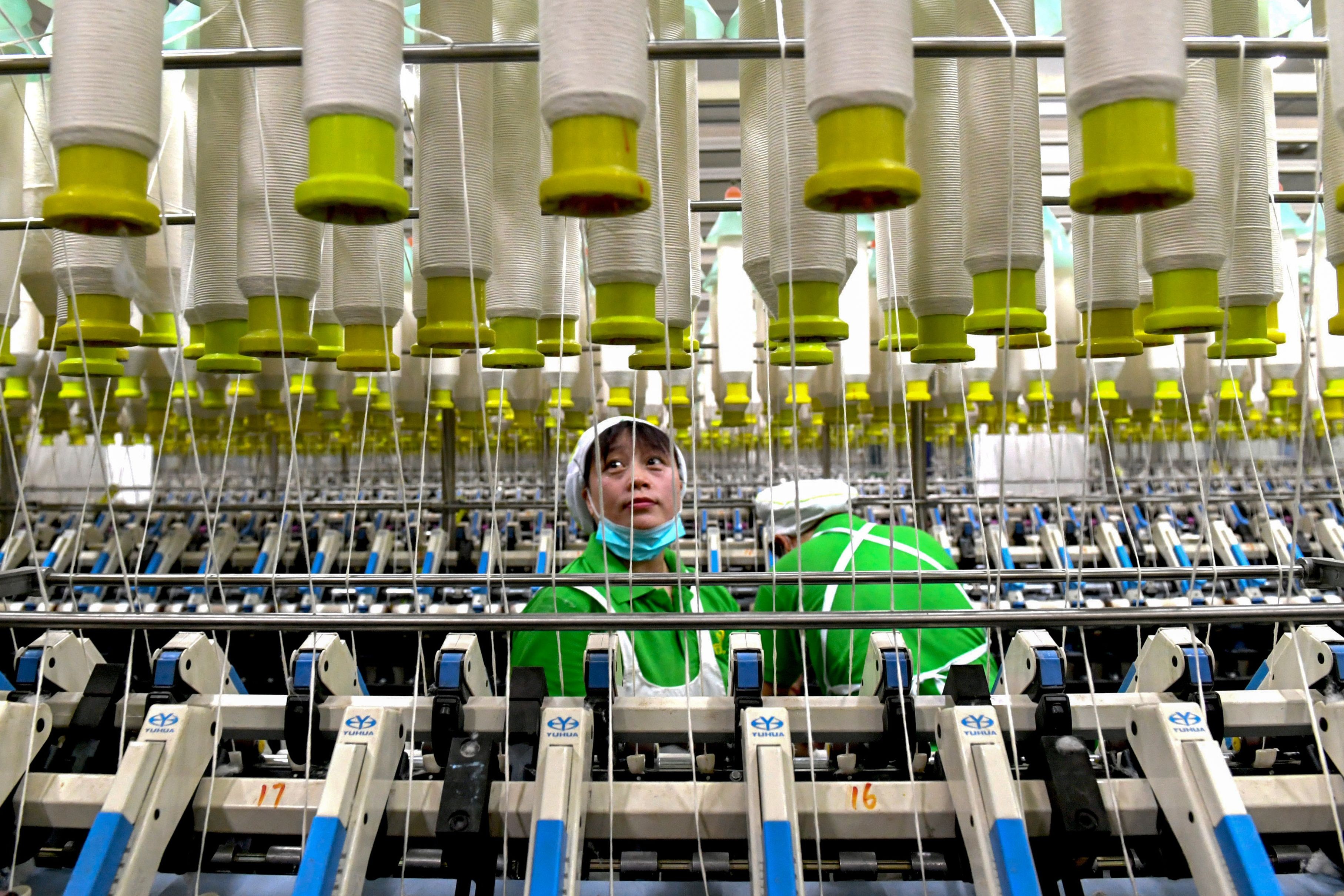 An employee works at a textile factory in Shangqiu in China’s central Henan province. The average nominal minimum wage in China nearly doubled between 2011 and 2018. Photo: STR/AFP