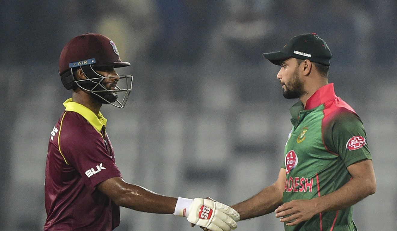 West Indies cricketer Shai Hope (left) shakes hands with Bangladesh cricket captain Mashrafe Mortaza (right). Photo: AFP