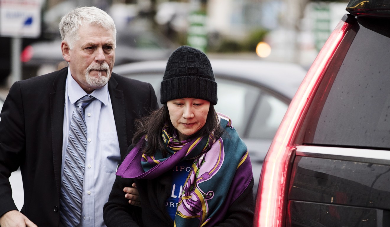 Sabrina Meng arrives at a parole office with a security guard in Vancouver on December 12. Photo: AP