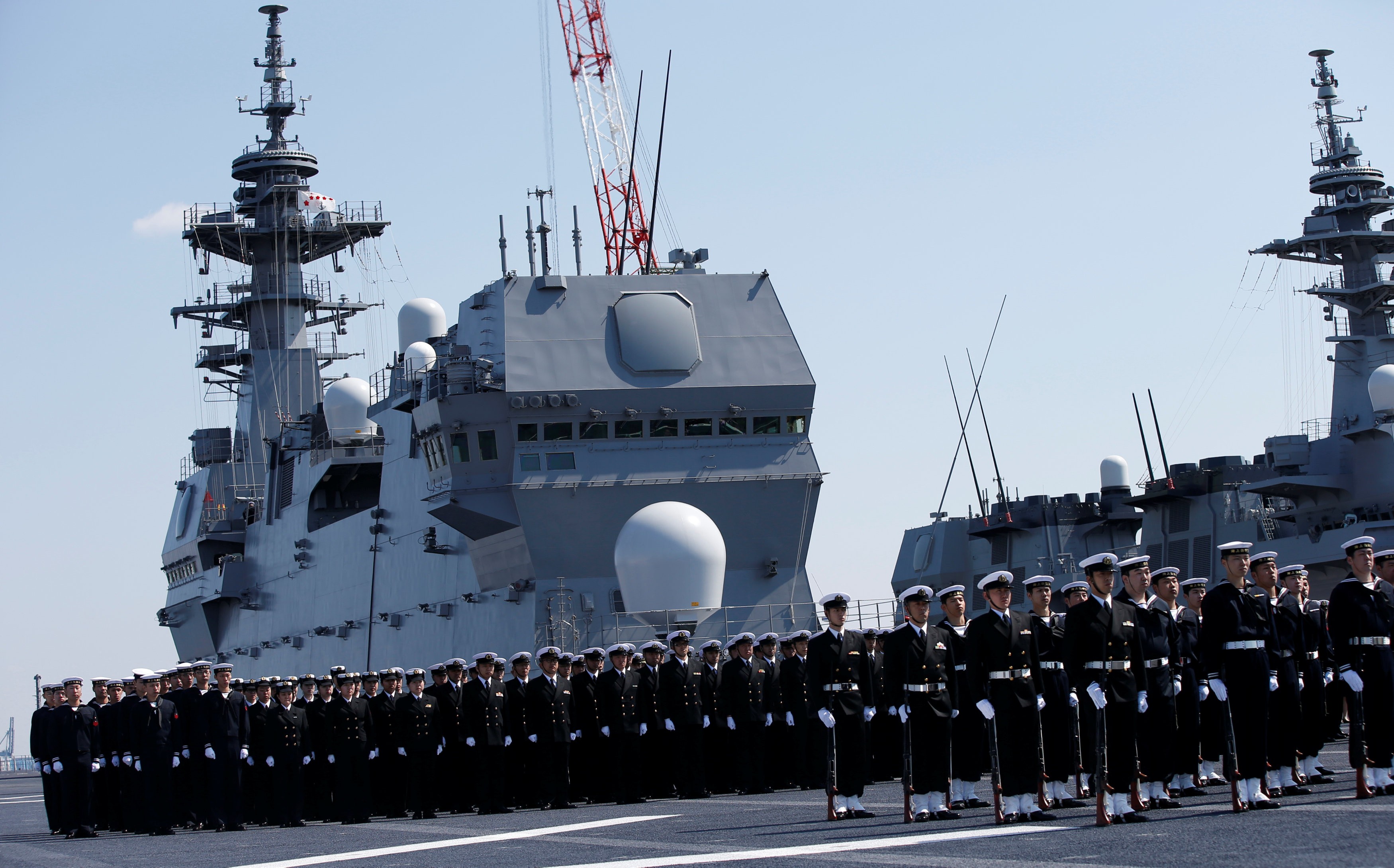 Members of the Japan Maritime Self-Defence Force attend a handover ceremony for the latest Izumo-class helicopter carrier JS Kaga (DDH-184) in Yokohama on March 22. Photo: Reuters