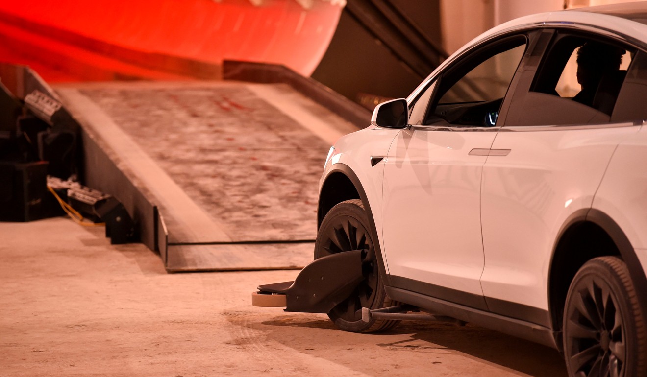 A modified Tesla Model X electric vehicle enters the tunnel with guide wheels attached. Photo: AFP