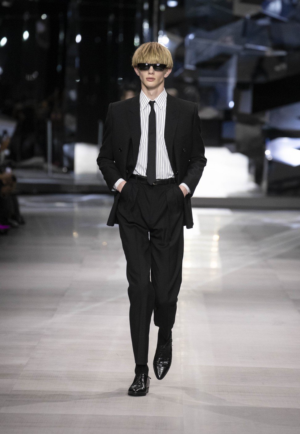 A model wears a well-tailored black suit from Celine’s menswear spring/summer 2019 collection show.