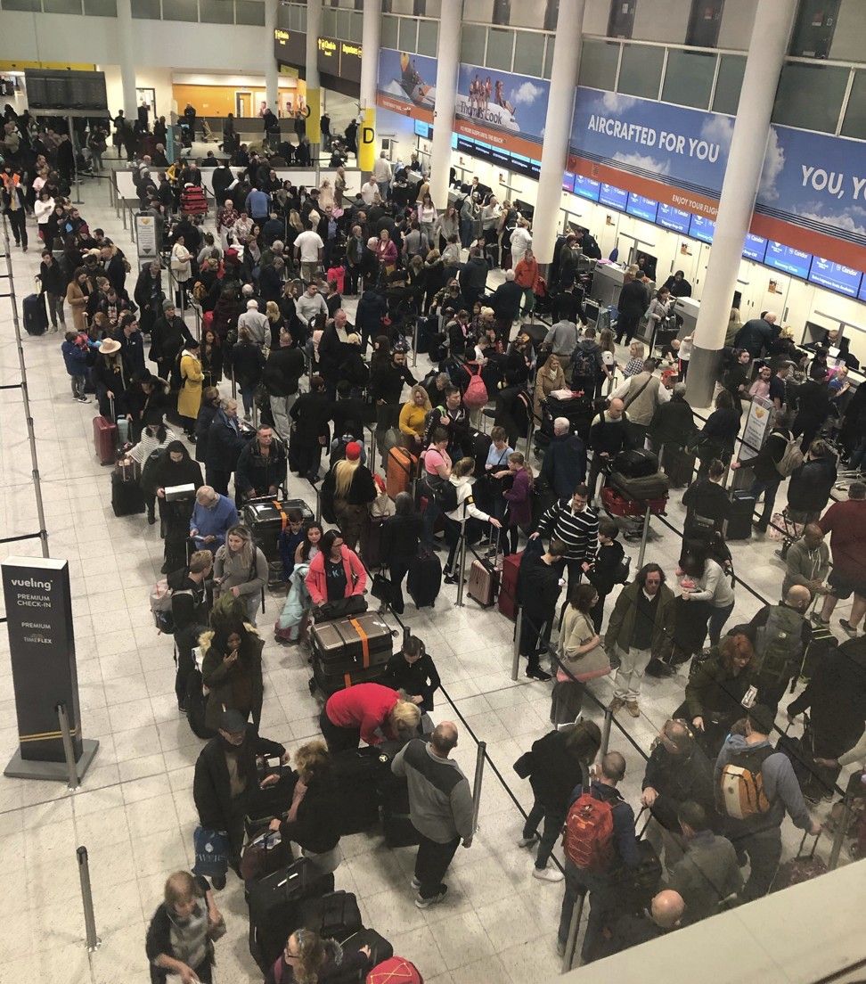 Queues of passengers wait at the check-in desks at Gatwick Airport. Photo: AP