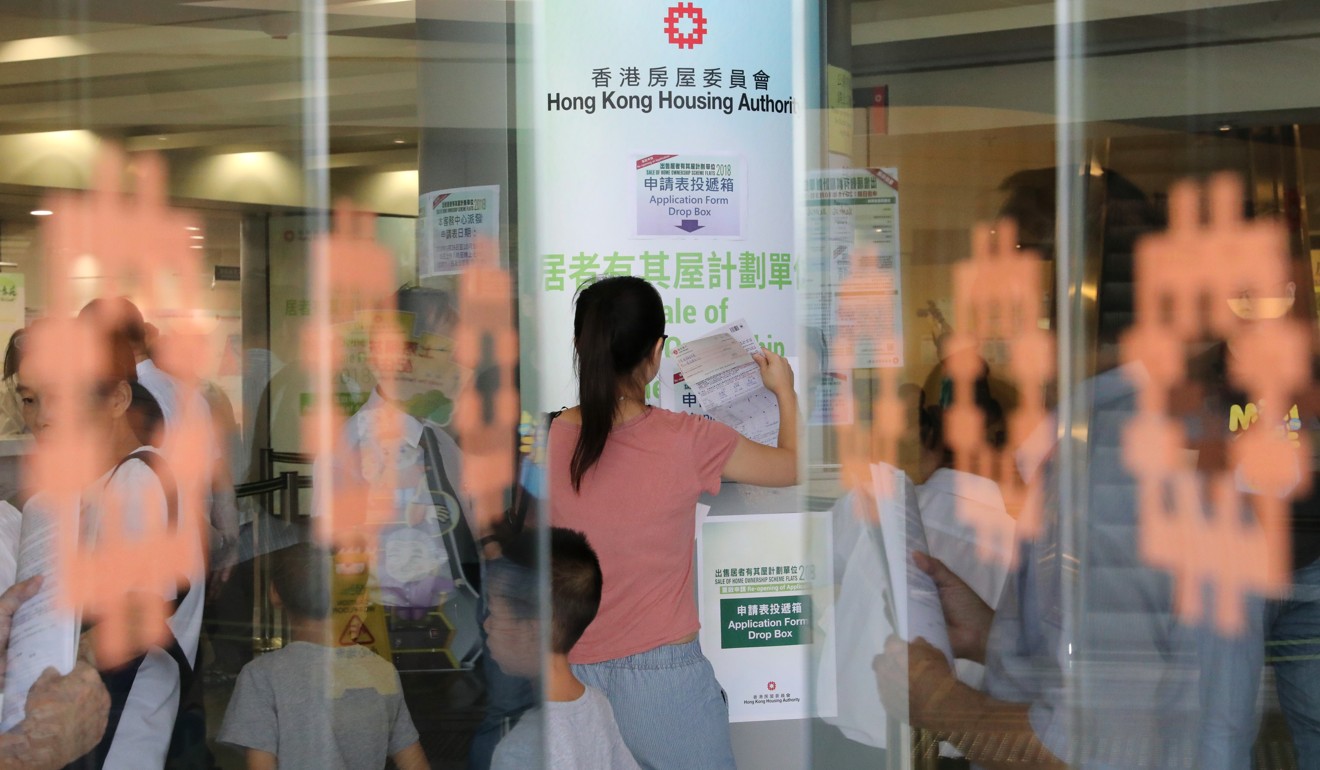 A woman submits her application form for the Sale of Home Ownership Scheme (HOS) Flats 2018. Photo: Felix Wong