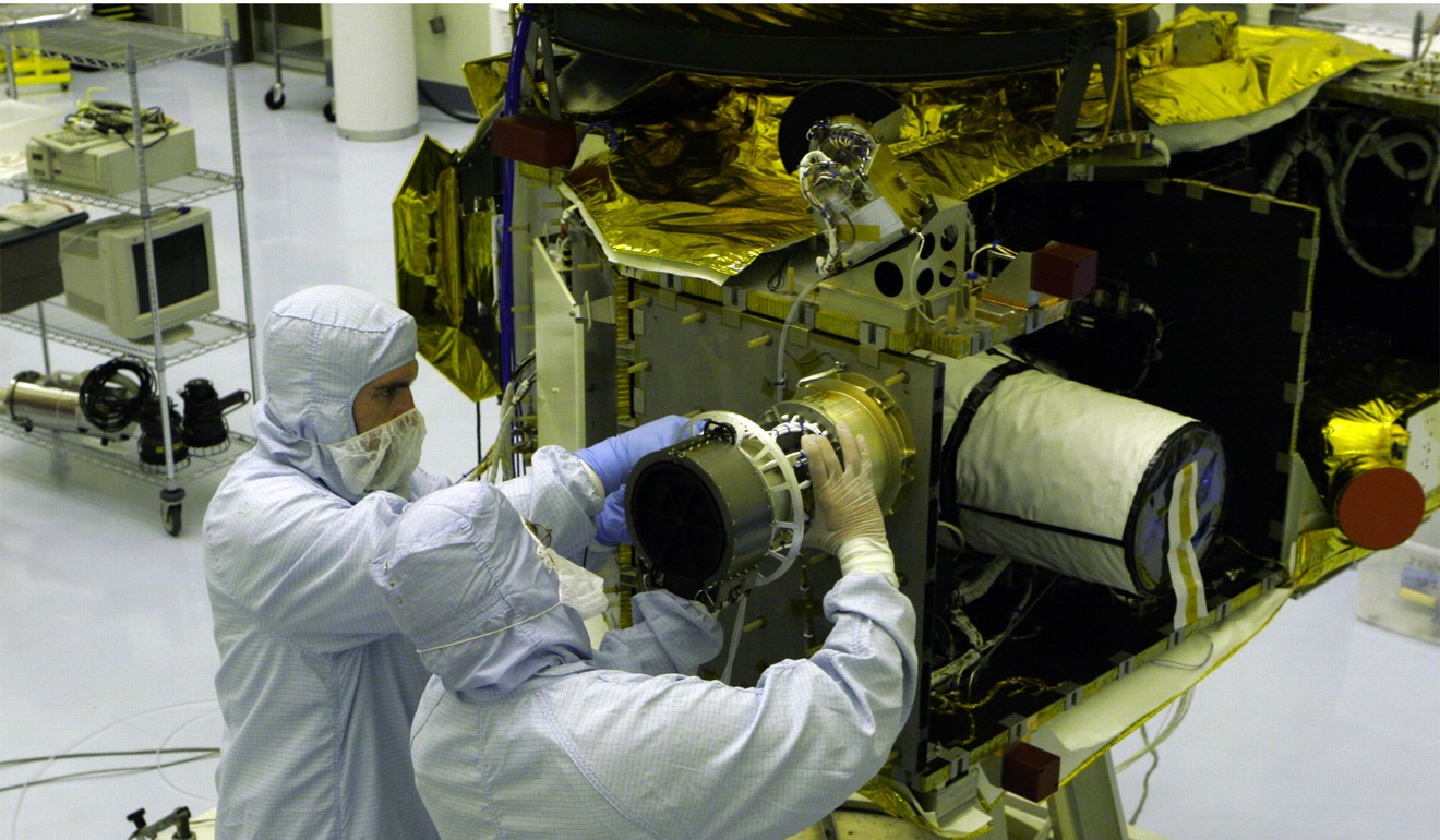 Scientists installing an instrument on the New Horizons spacecraft at Kennedy Space Centre. Photo: Nasa