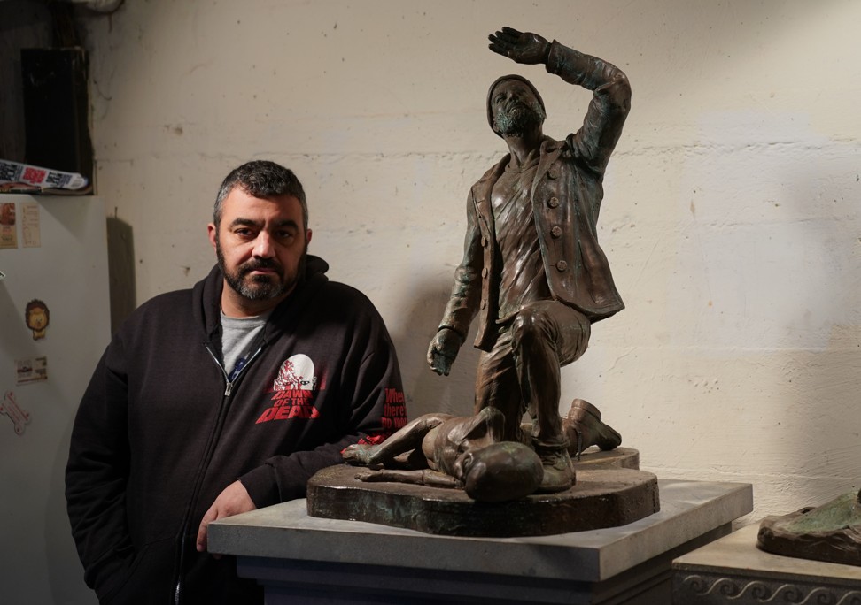 Reginella next to a sculpture dedicated to the crew of the tugboat Maria 120 which, according to the plaque on the pedestal, mysteriously vanished with the six man crew in New York’s harbour in July of 1977. Photo: AFP