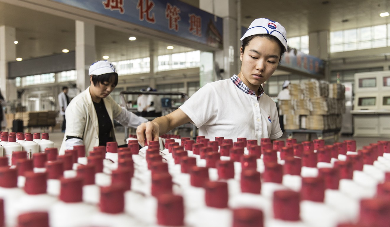 Employees arrange bottles of Moutai baijiu at the Kweichow Moutai factory in the town of Maotai in Renhuai, Guizhou province, in December 2017. The drinks industry is one Chinese consumer industry considered promising in terms of longer-term growth. Photo: Bloomberg