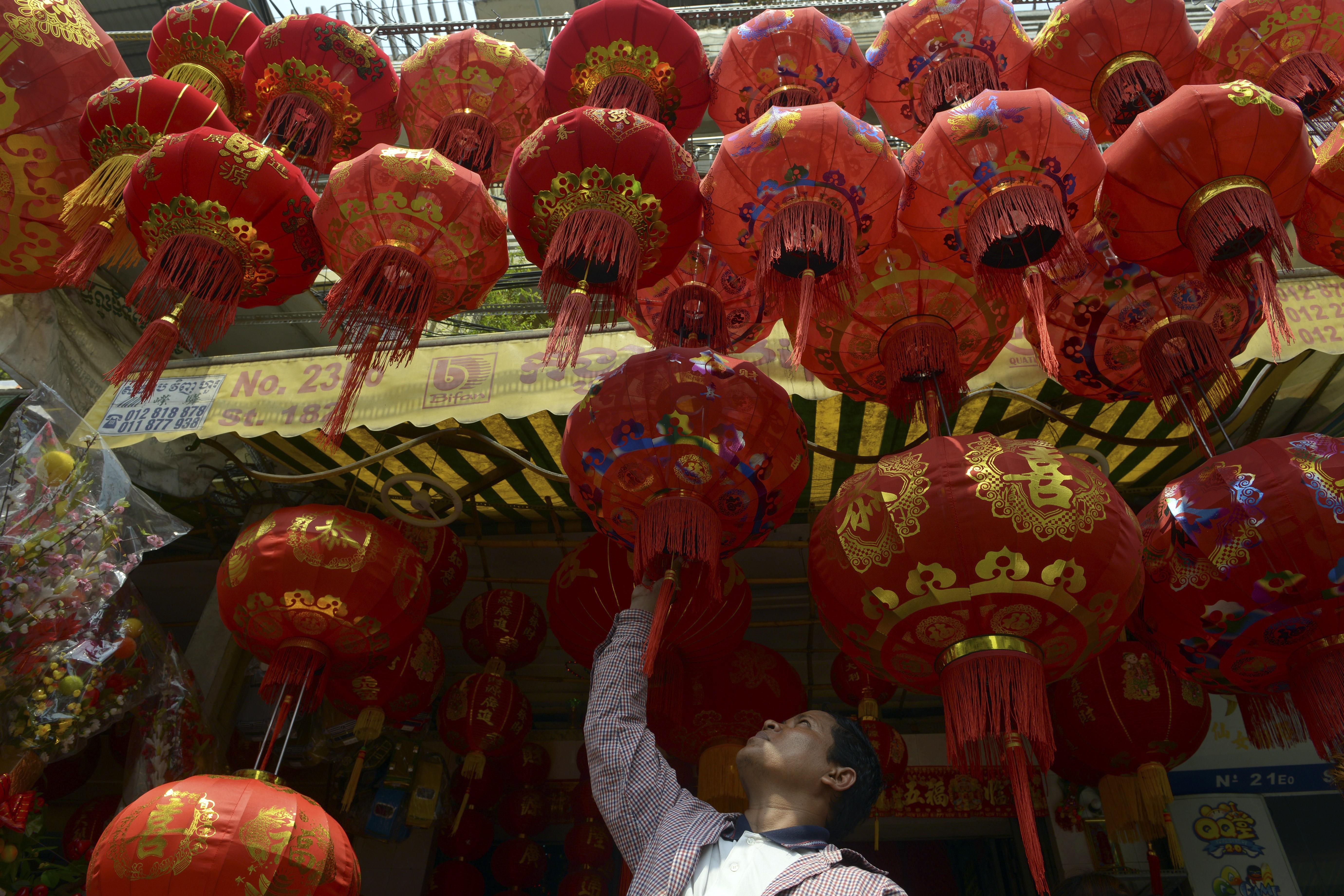 A Cambodian man looks at Chinese Lunar New Year lanterns at a shop in Phnom Penh. Photo: AFP