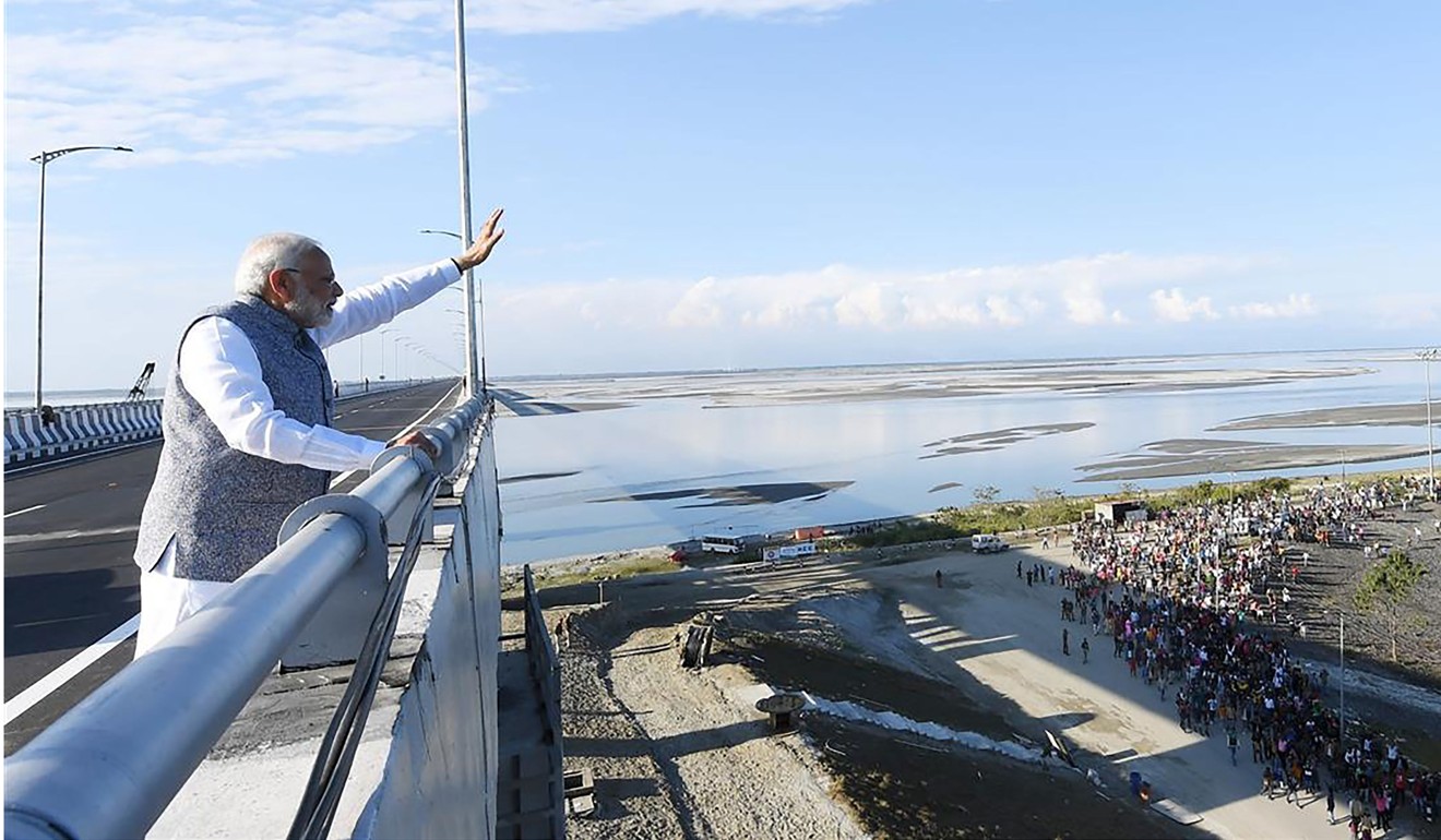 Modi waving at supporters from the newly-opened mega-bridge at Dibrugarh in Assam on December 25, 2018. Photo: AFP/PIB