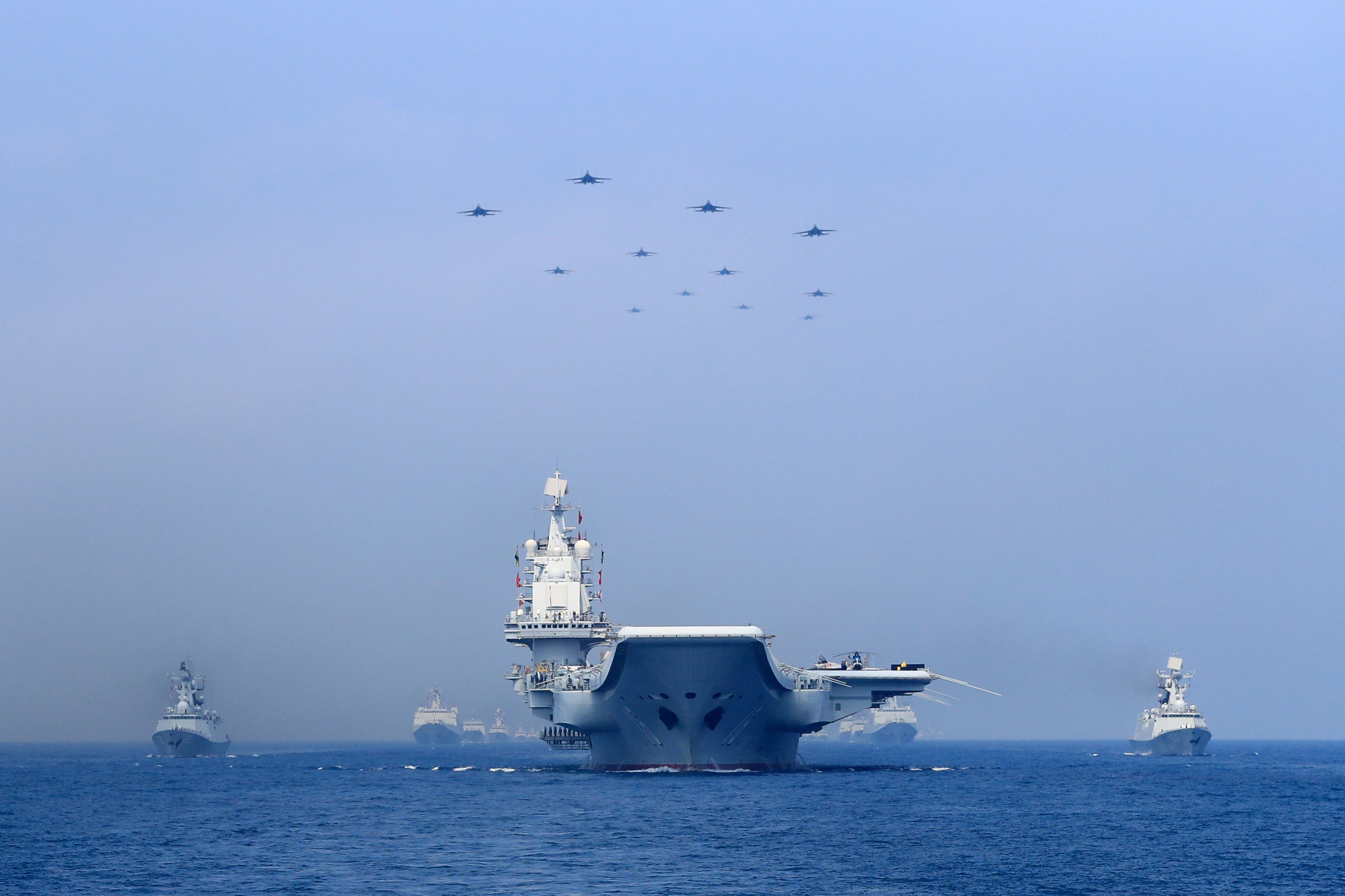 Warships and fighter jets of the Chinese People’s Liberation Army (PLA) Navy taking part in a military display in the South China Sea on April 12, 2018. Photo: Reuters