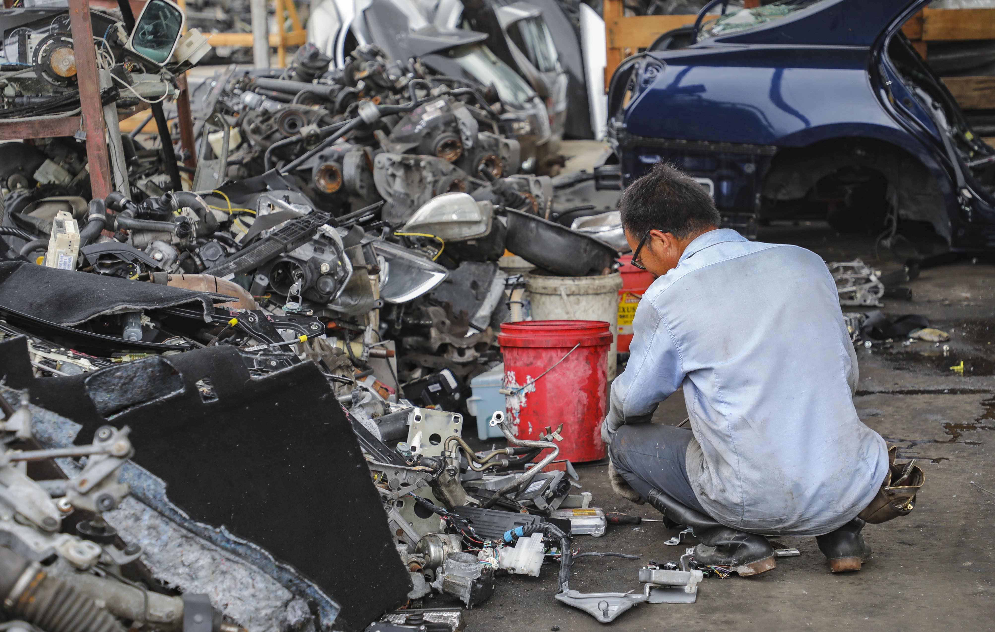 A man works at a recycling yard for vehicle parts operating on a brownfield site in Wang Toi Shan in Yuen Long in May 2018. The proposal to redevelop brownfield sites in the New Territories received strong public support in the Task Force on Land Supply’s public engagement exercise, but resettling existing businesses will be not be easy. Photo: Edward Wong