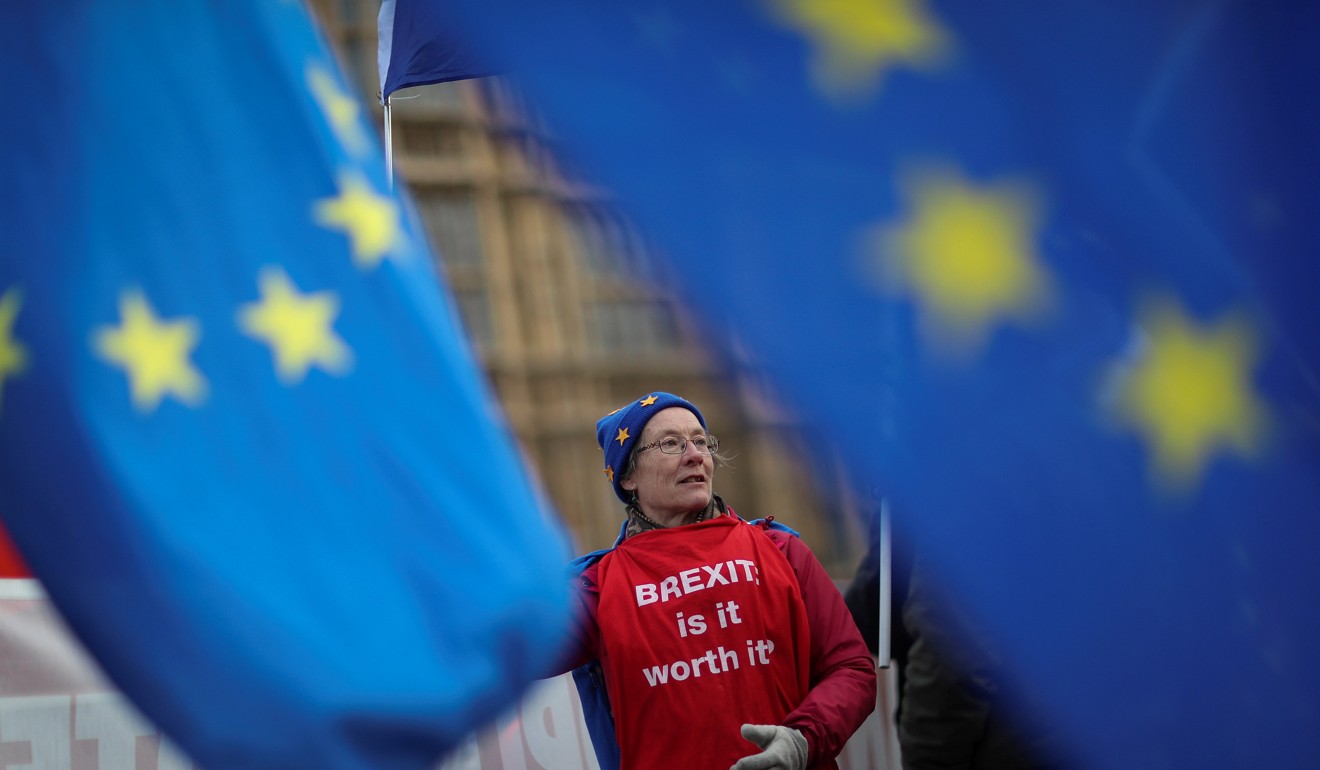 An anti-Brexit protester waves a flag outside the Houses of Parliament in London. Photo: Reuters