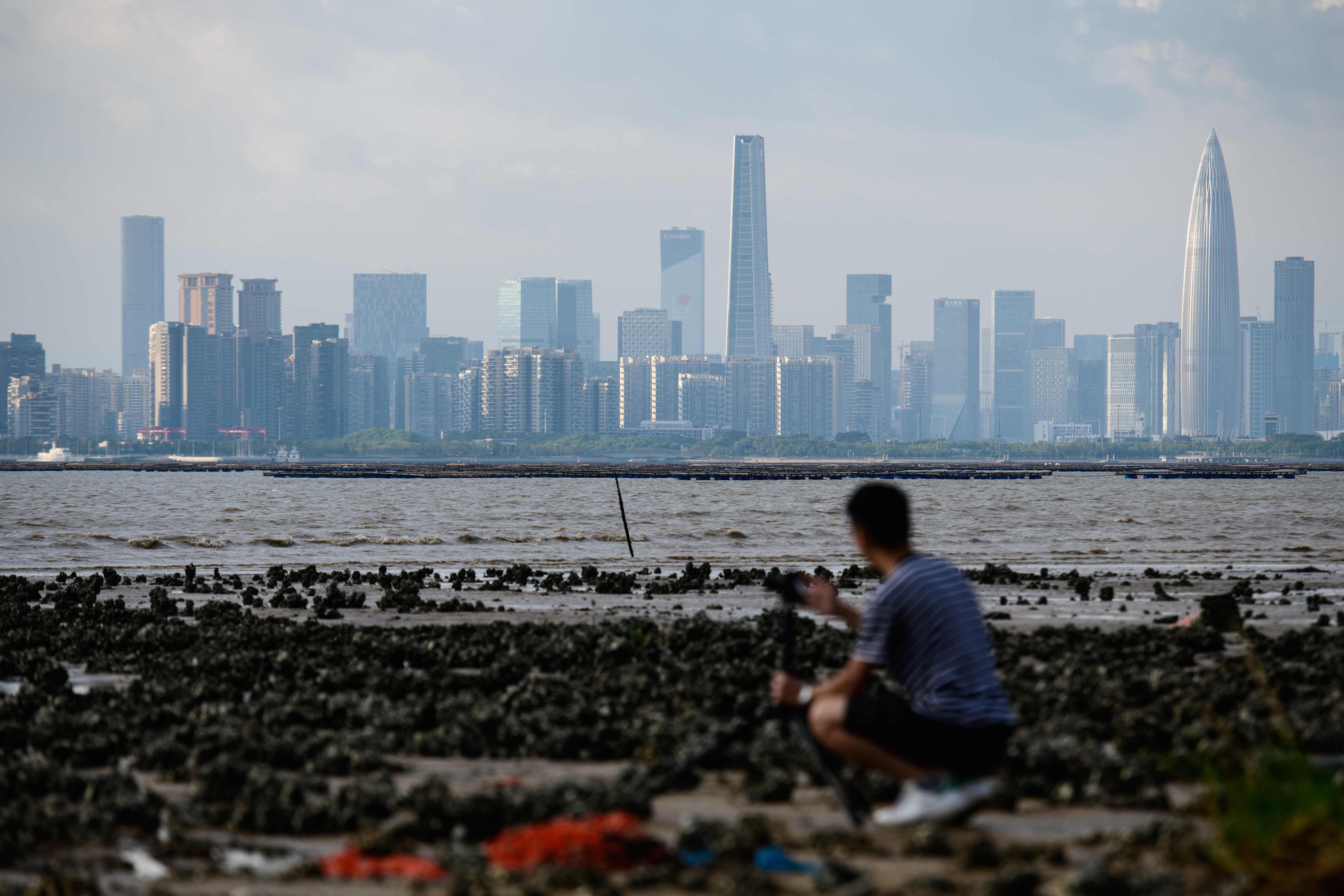 A man looks across Deep Bay towards Shenzhen. Being closest to Shenzhen and the other Greater Bay Area cities, New Territories North could more easily build economic links with these cities. The area not only serves the 7.3 million people in Hong Kong but also potentially the 40 million in the eastern part of the Greater Bay Area, encompassing Shenzhen, Dongguan, Guangzhou and Huizhou. Photo: AFP
