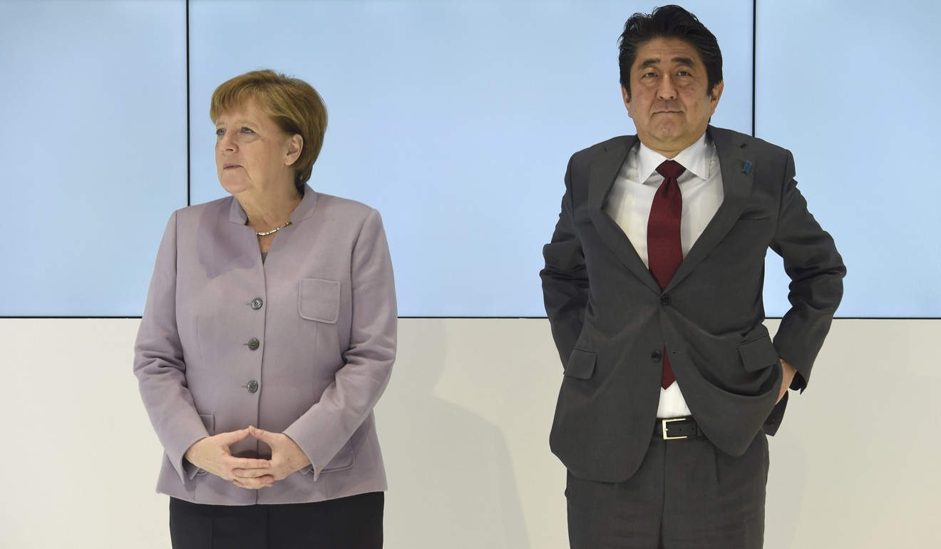 German Chancellor Angela Merkel and Japanese Prime Minister Shinzo Abe will both be at Davos. Photo: Reuters
