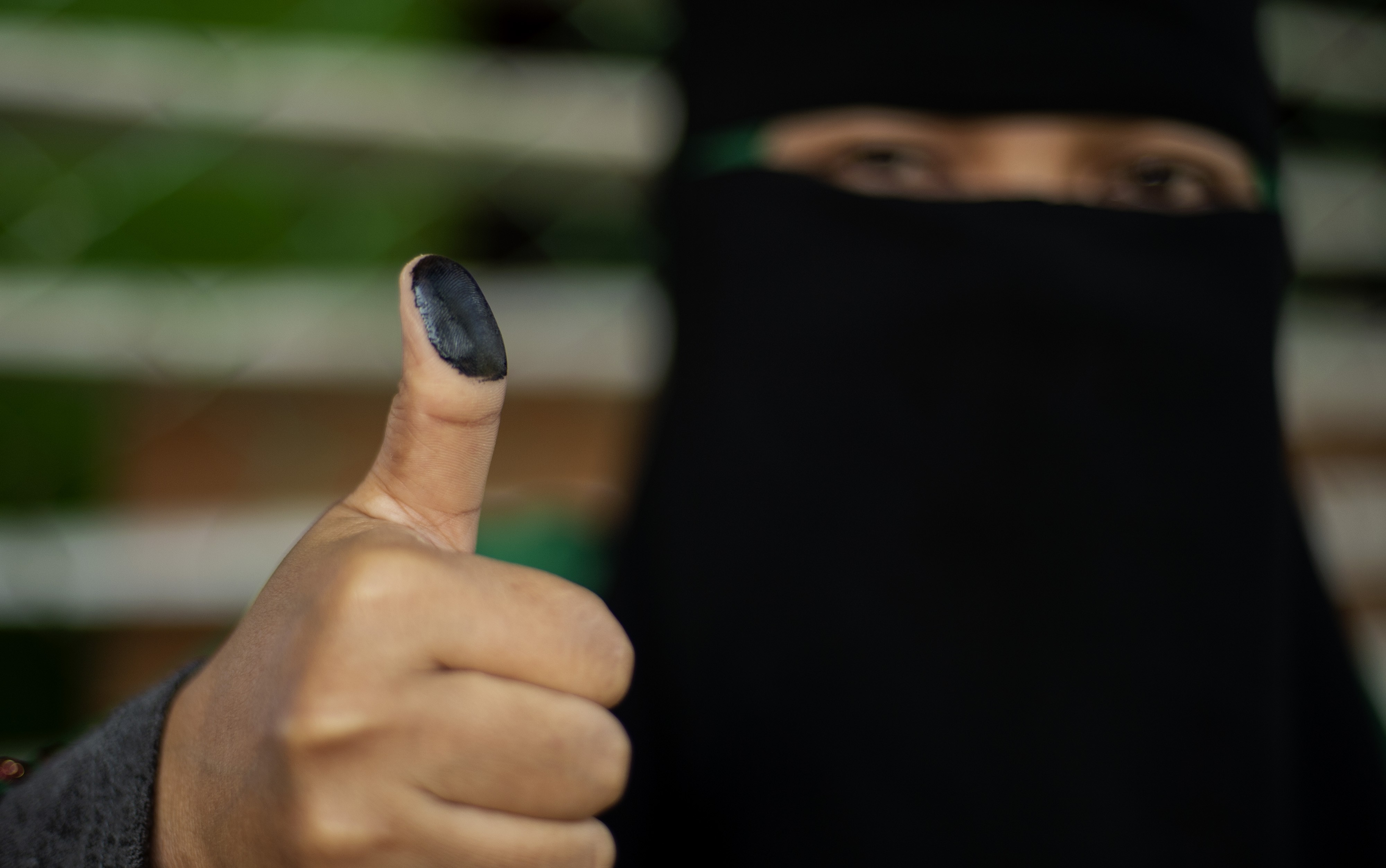 A woman shows her inked thumb after voting in Cotabato City. Photo: AFP