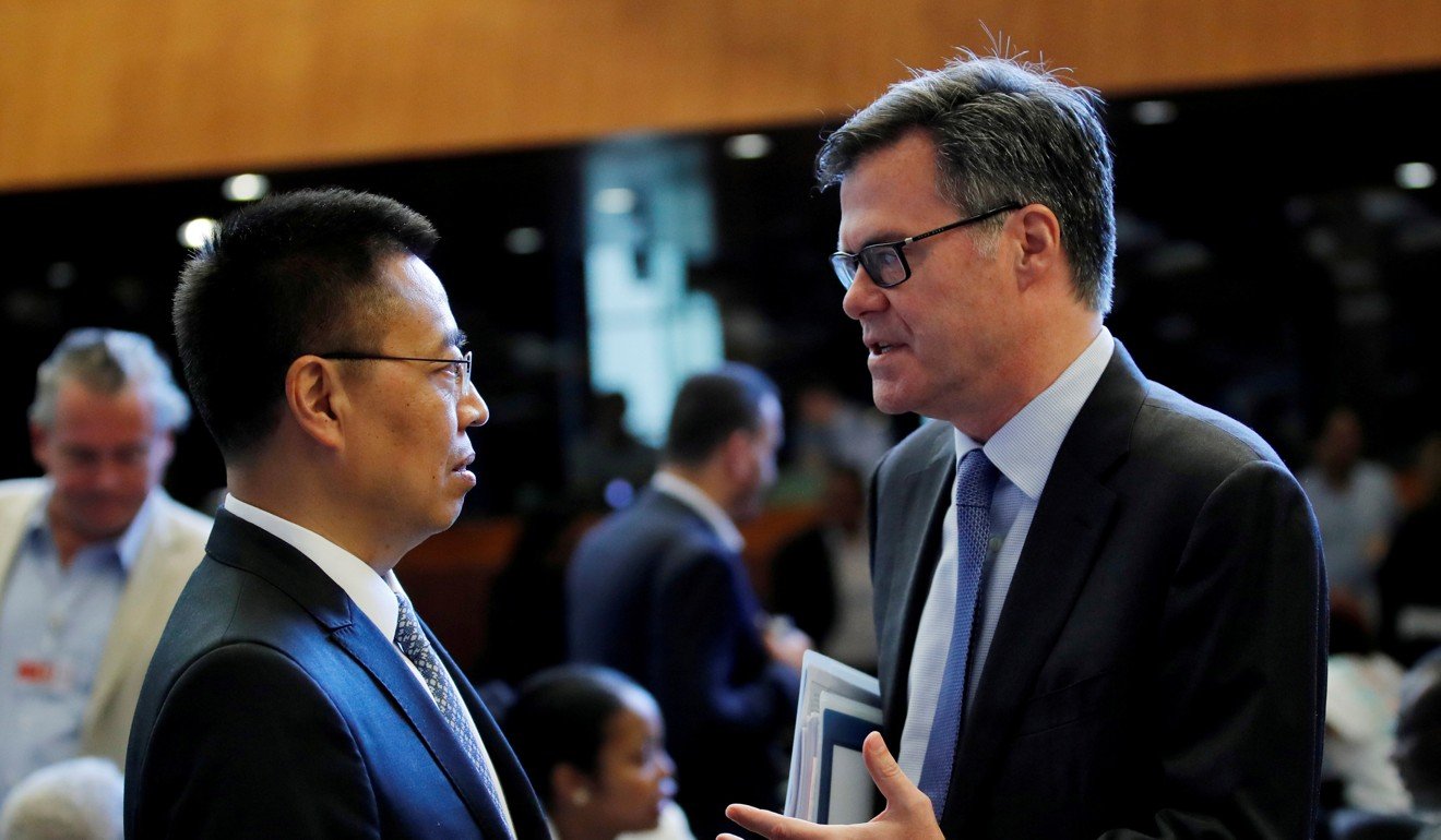 Dennis Shea, US ambassador to the World Trade Organisation, talks with Chinese ambassador Zhang Xiangchen before the General Council meeting at the WTO in Geneva in July 2018. China’s membership in the WTO, achieved in December 2001, signified its integration into the global economy but its growth and lack of democratic reform since then has made some questions whether its membership should have been allowed. Photo: Reuters
