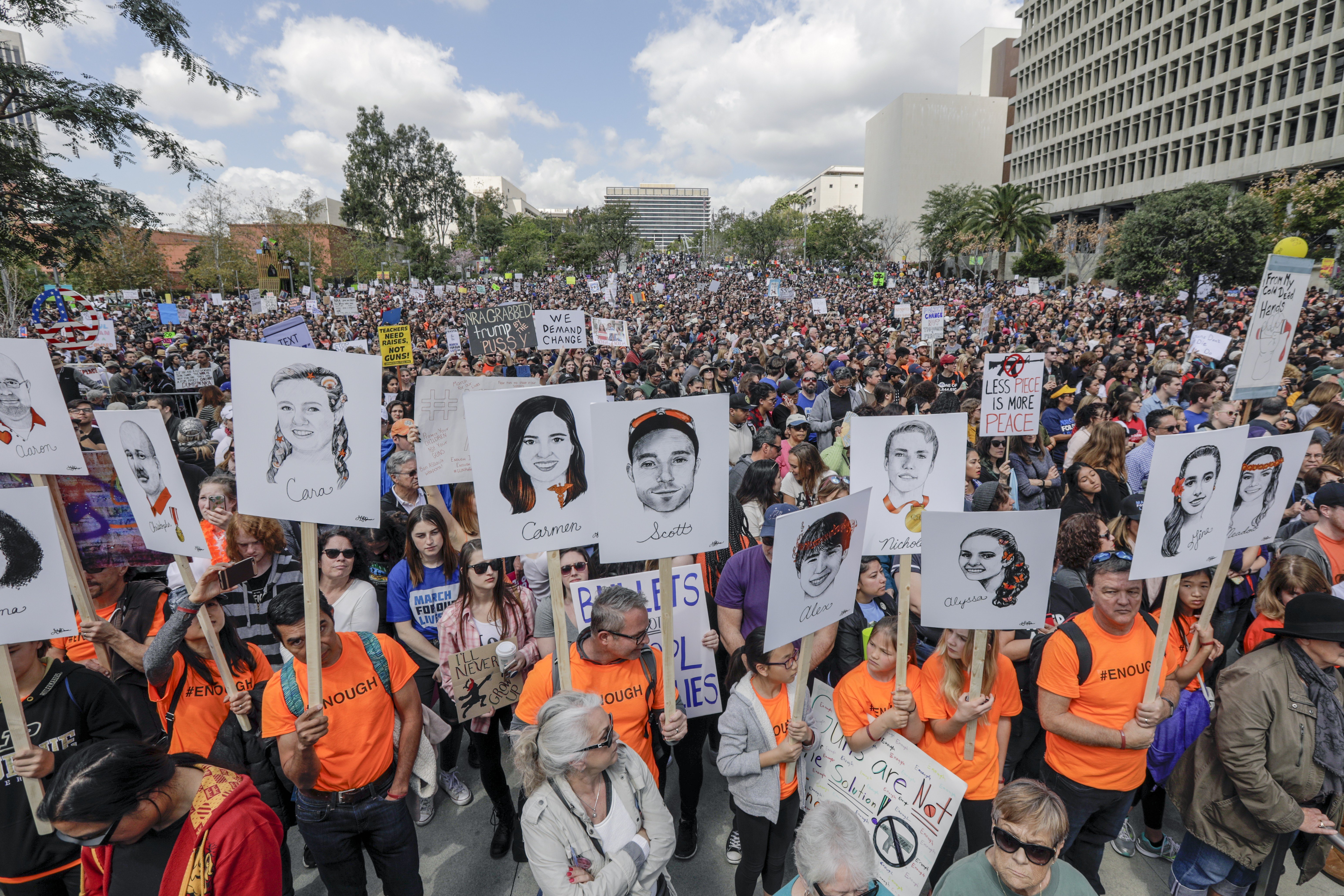 Marchers carry the portraits of 17 who lost their lives in the Parkland High School shooting, drawn by Gracie Pekrul, 16, student of Simi Valley Oak Park Independent School, at the March For Our Lives rally in Los Angeles on Saturday, March 24, 2018. (Irfan Khan/Los Angeles Times/TNS)