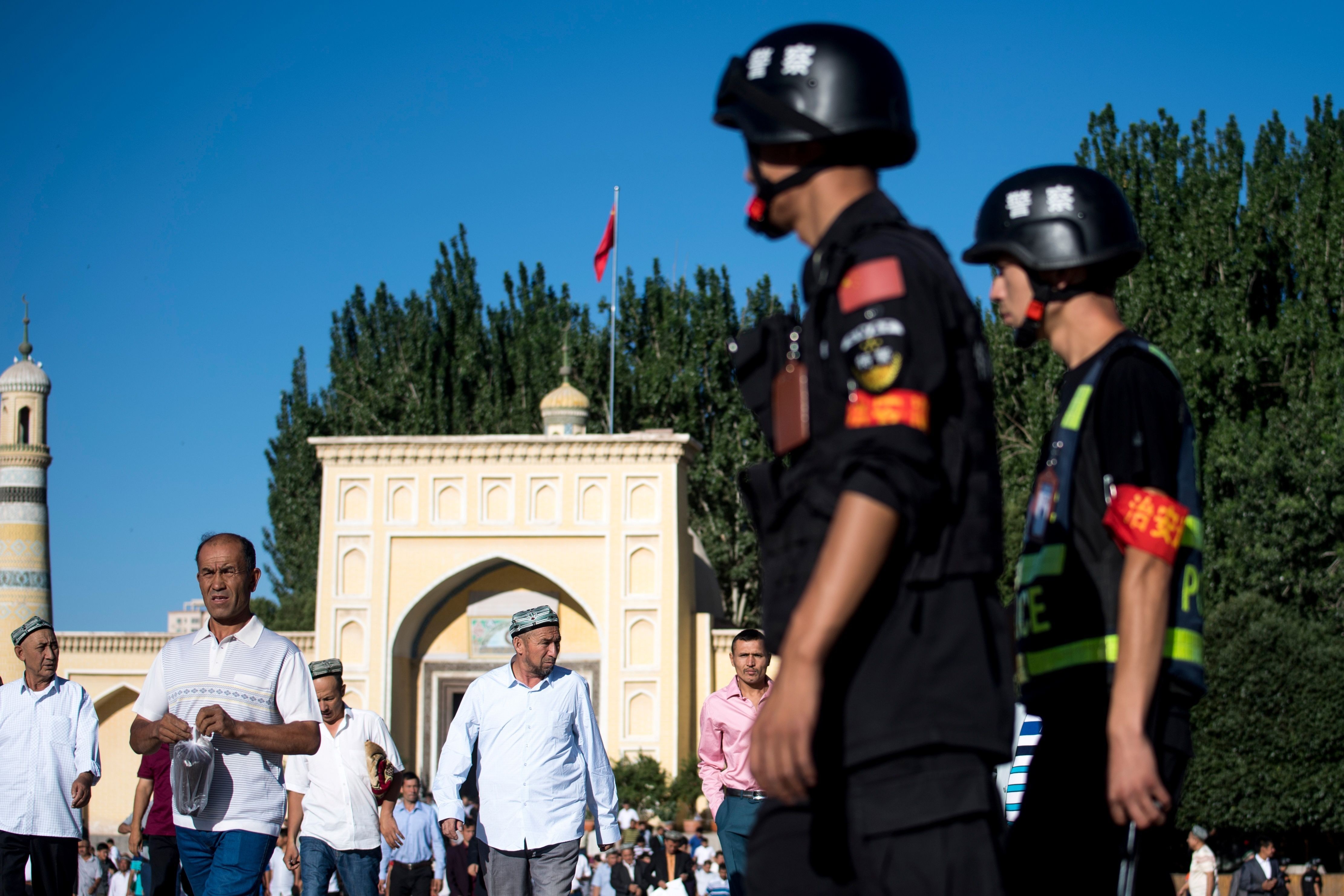 Police patrol outside the Id Kah Mosque in Kashgar, Xinjiang, after morning prayers. Photo: AFP