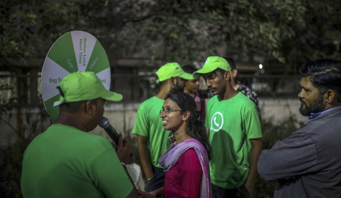 A WhatsApp ambassador speaks with a spectator during a roadshow for WhatsApp. Photo: Bloomberg