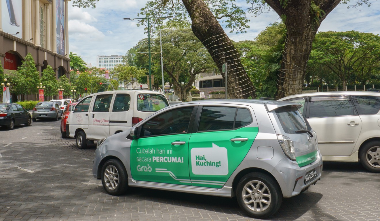 A car with a Grab advertisement in Malay. Photo: Shutterstock