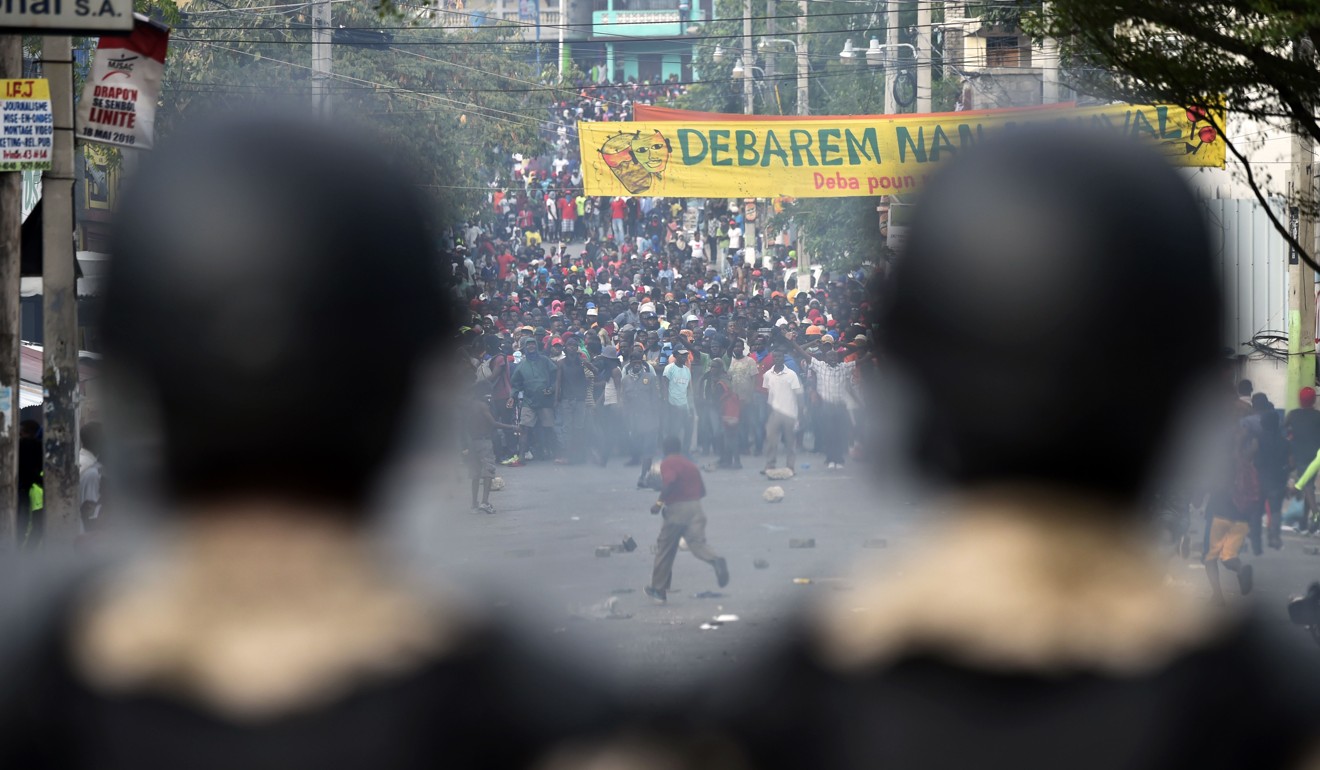 Haitian police clashes with demosntrators, in the center of Haitian capital Port-au-Prince on February 12. Photo: AFP