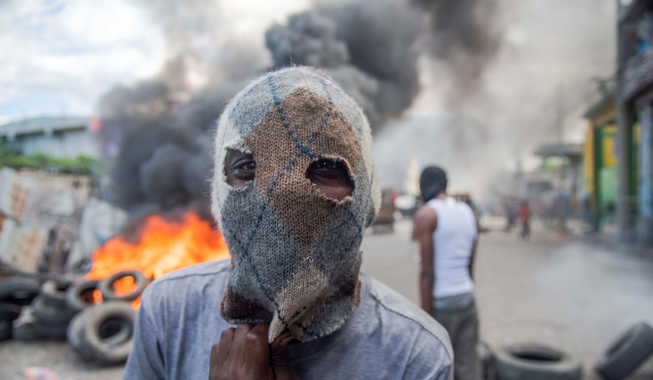 Protest wear masks during rallies in Port-au-Prince, Haiti, on February 10. Photo: EPA