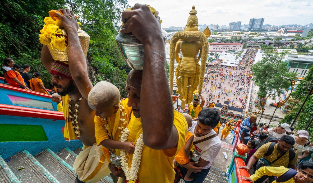 The faithful climb the long stairway leading to the Hindu temples at Batu Caves. Photo: Alamy