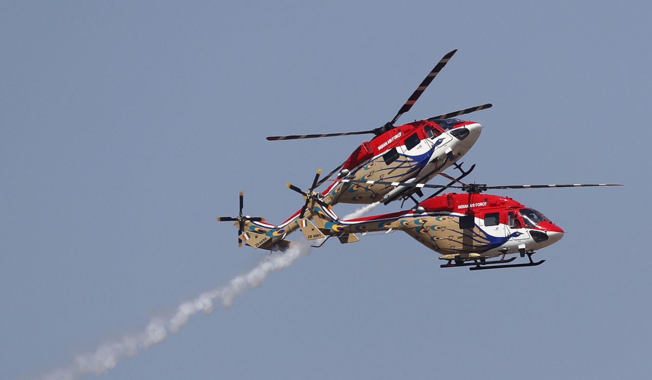 Indian Air Force Dhruv helicopters perform aerobatic manoeuvres at a rehearsal ahead of the Aero India 2019. Photo: AP