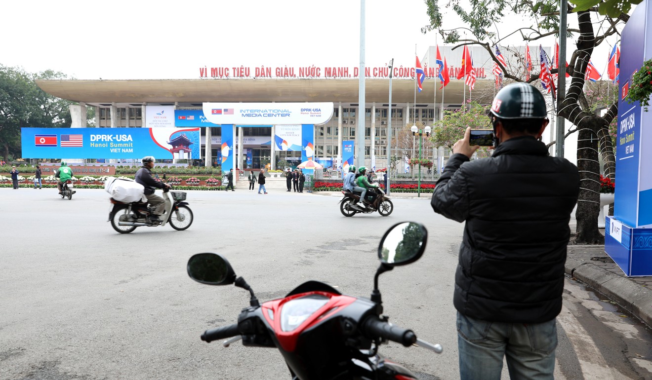 A man takes photos of the International Media Centre in Hanoi. Photo: Xinhua