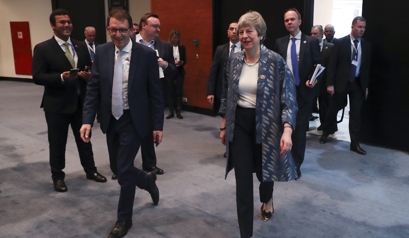 British Prime Minister Theresa May, centre, walks in the hallway at an EU-Arab summit at the Sharm el-Sheikh convention centre. Photo: AP Photo