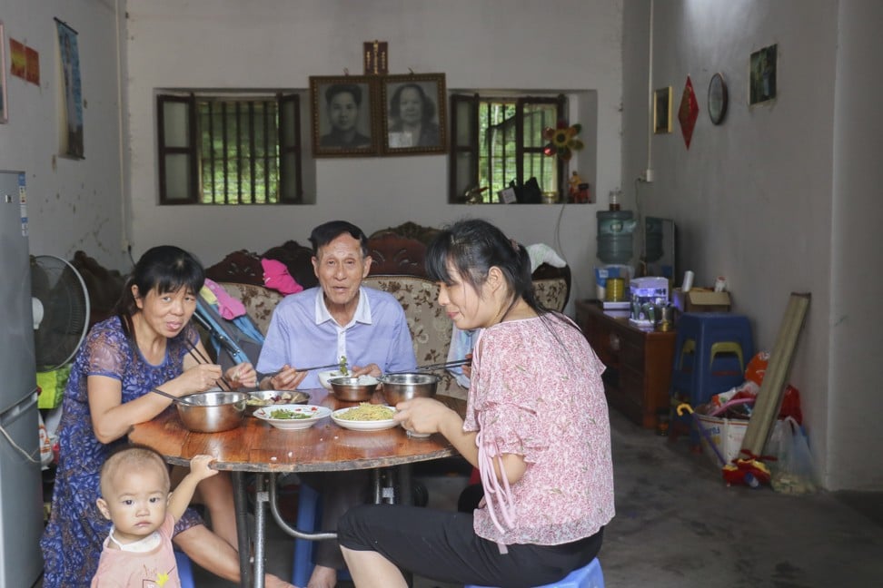 Mr He and his family eat lunch in Maosheng. Picture: Thomas Bird
