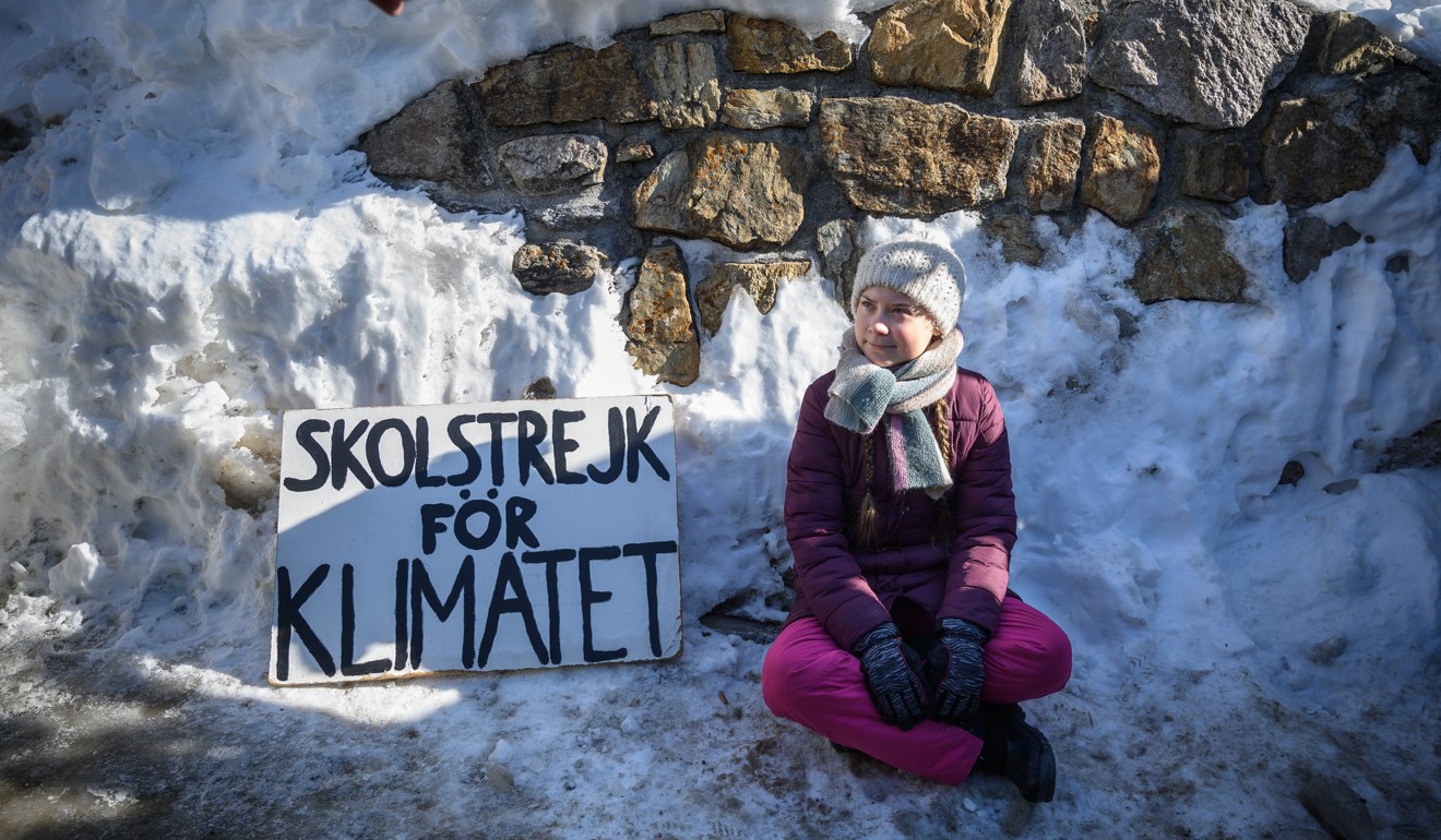 Swedish activist Greta Thunberg, 15, sits next to a placard reading “school strike for climate” at the World Economic Forum annual meeting, on January 25, in Davos, Switzerland. On Thursday European Commission president, speaking alongside Greta, said the European Union should spend a quarter of its budget for the next seven years on climate change mitigation. Picture: AFP