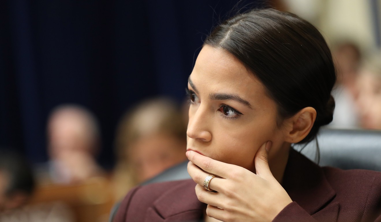 Representative Alexandria Ocasio-Cortez, a Democrat from New York, listens during a House Oversight Committee hearing with Michael Cohen. Photo: Bloomberg