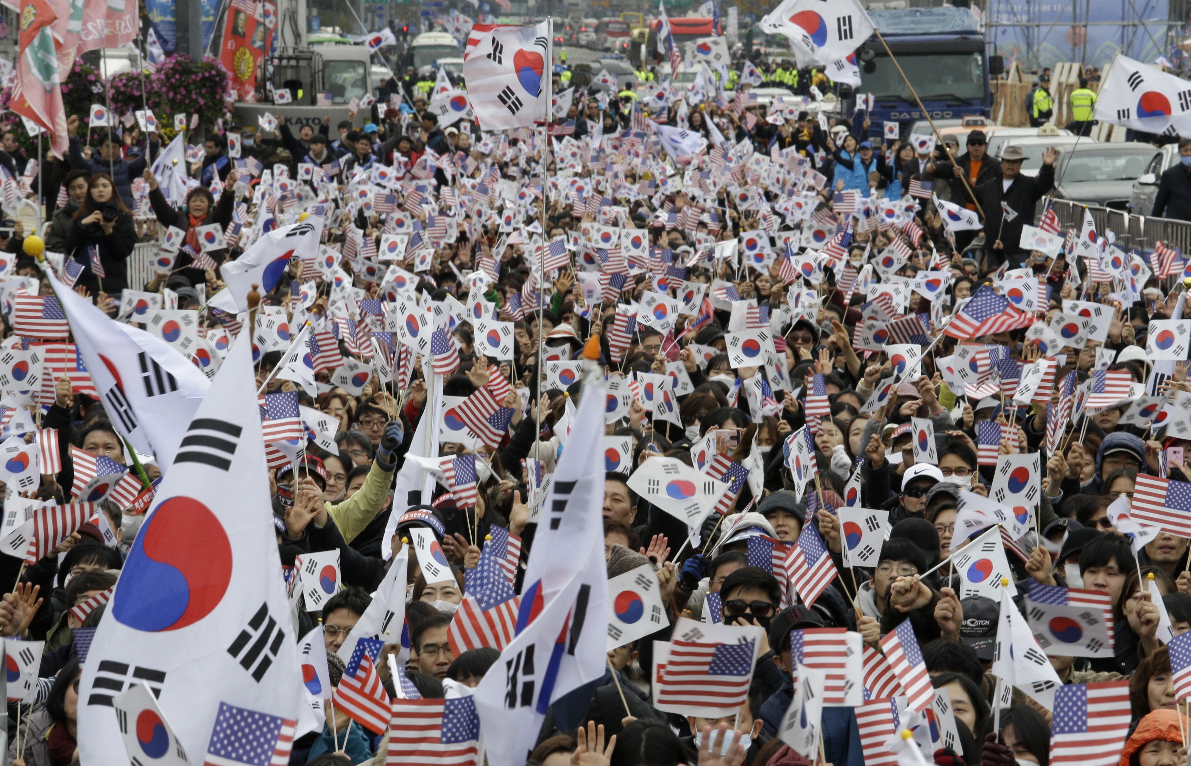 Protesters wave South Korean and US flags during a rally denouncing South Korean President Moon Jae-in in Seoul in November 2018. Moon’s once sky-high approval ratings have fallen to earth over the country’s economic performance, and his support for negotiations between Donald Trump and Kim Jong-un have not paid off so far. Photo: AP