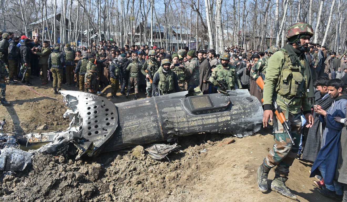 Indian soldiers and Kashmiri onlookers stand near the remains of an Indian Air Force aircraft after it crashed 30km from Srinagar, in Indian-controlled Kashmir, on February 27. Photo: AFP