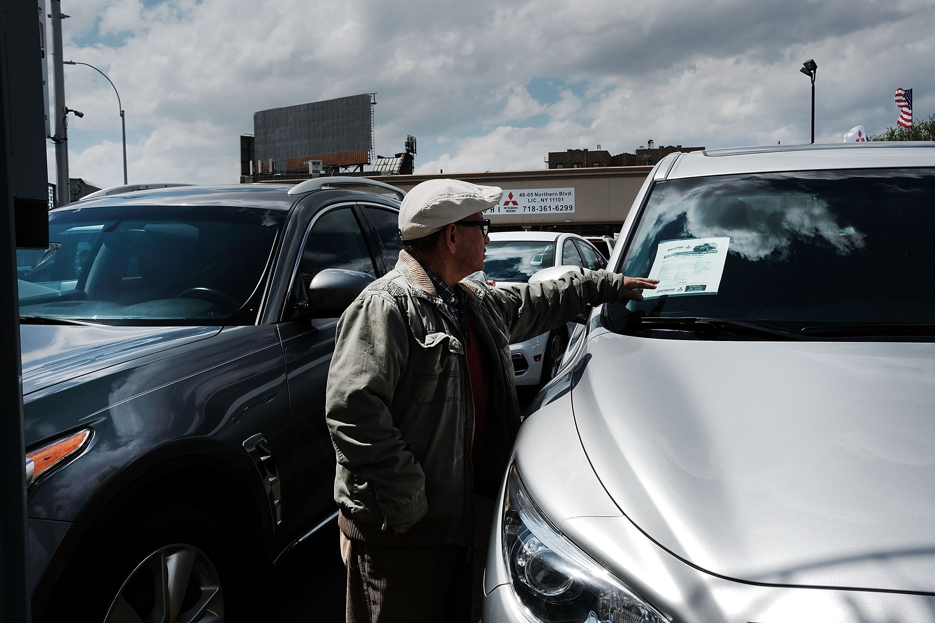 A man looks at cars for sale at an auto showroom in May 2017 in the Queens borough of New York City. The US has averaged about 17.5 million in annual car sales in the last three years. Photo: Getty Images via AFP