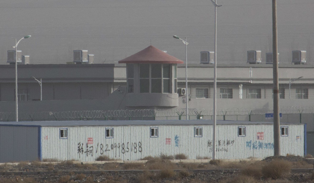 A guard tower and barbed wire around a camp and training facility in Artux, Xinjiang. Photo: AP