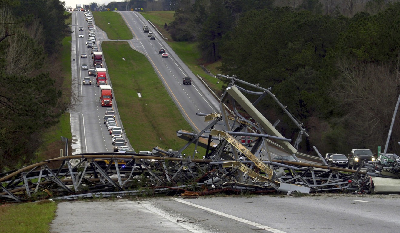 A fallen mobile phone tower lies across US Route 280 highway in Lee County, Alabama. Photo: AP